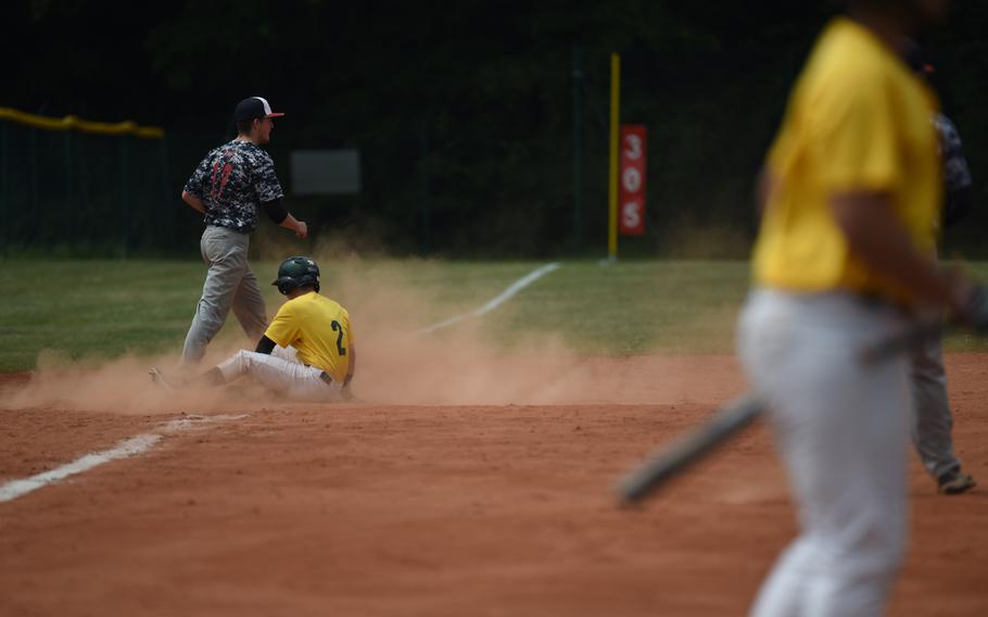 Alconbury's James Wood slides in safe at third after banging a triple against Bitburg in pool play at the DODDS-Europe baseball championships.