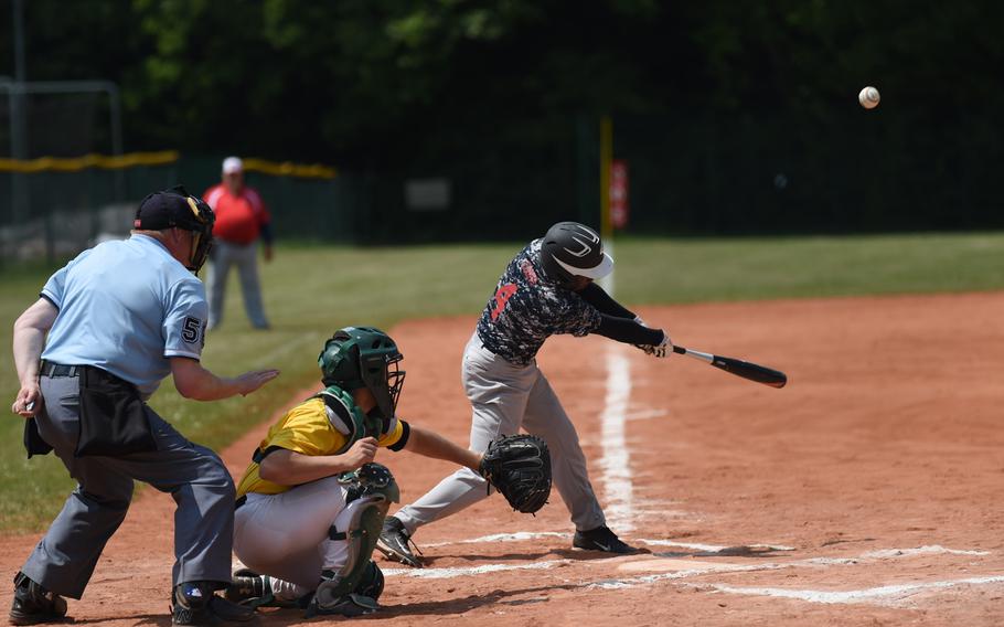 Bitburg's Jermaine Cooks dings a single in the Barons' pool-play game against Alconbury at the DODDS-Europe championships.