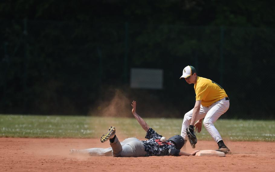 Bitburg's Andrew Bailey dives back to second after driving in three runs on a double against Alconbury Friday in pool play at the DODDS-Europe baseball championships. 