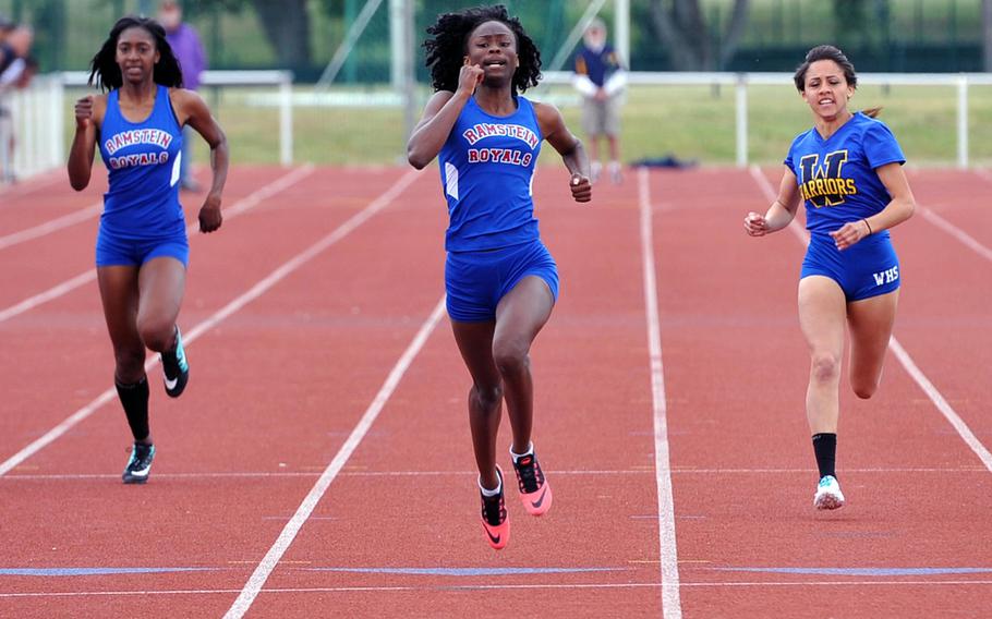Ramstein's Sinoda Emanuel, center, sprints to the finish line to win the girls 200-meter dash in 25.21 seconds at the DODDS-Europe track and field championships in Kaiserslautern, Germany, Saturday, May 23, 2015. Amelya Hempstead of Wiesbaden, right, finished second, while Ramstein's Denee Lawrence, left, was third.