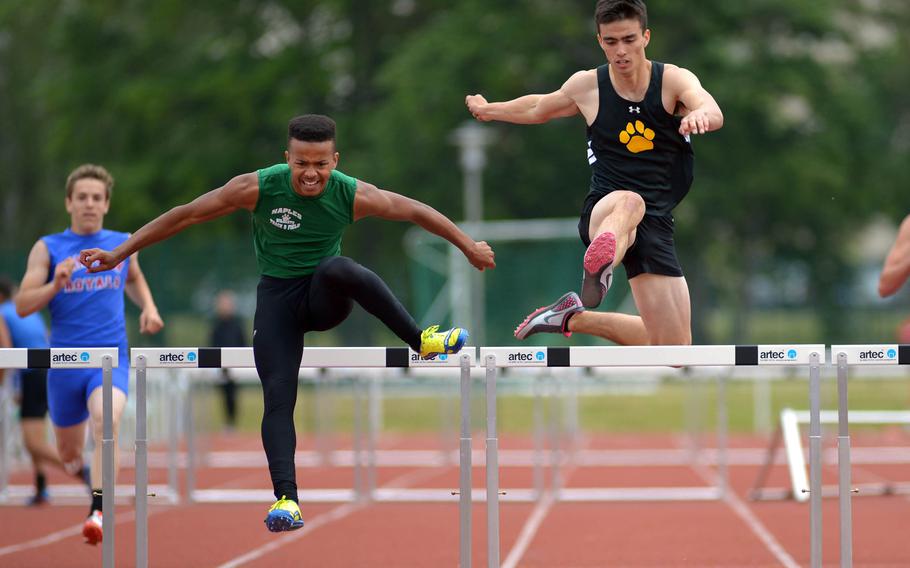 Naples' Nick Snider, left, and Patch's Lewis Moorhead clear the final hurdles in the boys 300-meter race at the DODDS-Europe track and field championships in Kaiserslautern, Germany, Saturday, May 23, 2015. Snider won in 40.42 seconds, ahead of Moorhead who ran a 40.59.