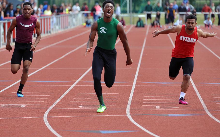Naples' Cameron Copeland reacts as he wins the boys 100-meter dash in 10.91 seconds at the DODDS-Europe track and field championships in Kaiserslautern, Germany, Saturday, May 23, 2015. Copeland also won the boys 200-meter race in 22.14 seconds. At left is Vilseck's Navante Hinds, at right Aviano's Dimitri Dawson.