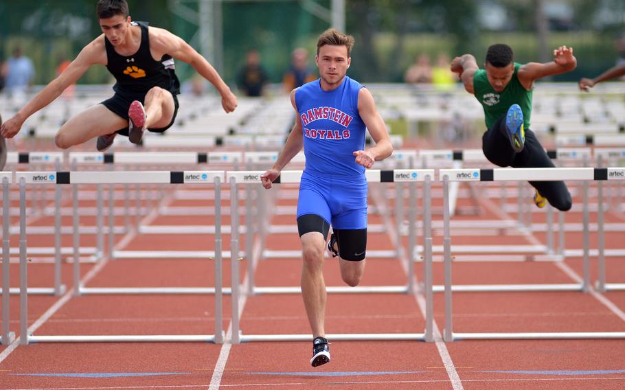 Ramstein's Chandler Henderson eyes the finish line on his way to winning the 110-meter hurdle race in 15.58 seconds at the DODDS-Europe track and field championships in Kaiserslautern, Germany, Saturday, May 23, 2015. At left is second-place finisher Lewis Moorhead of Patch, at right Nick Snider of Naples who finished third.