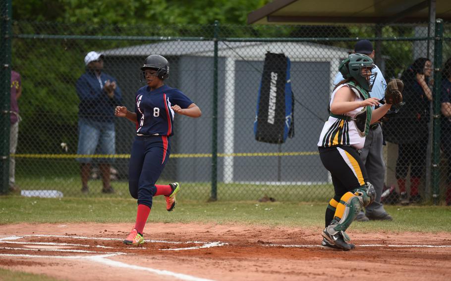 Aviano junior De'Ja Knight scores on a double by junior Ashley Mills in the Saints' 8-3 win over Alconbury for the DODDS-Europe Division II/III softball championship.