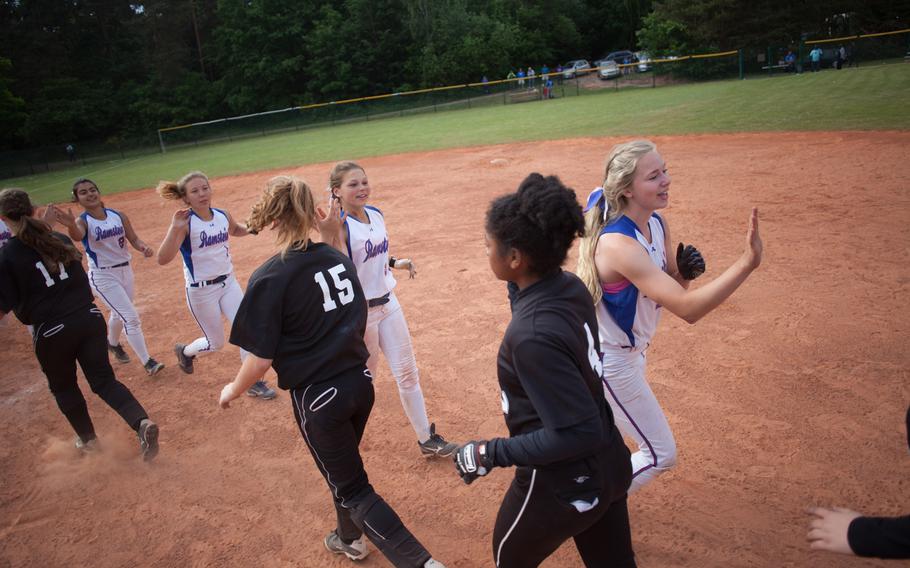 Vilseck and Ramstein high-five after the DODDS-Europe Division I softball game, which Ramstein won with a razor-thin 7-6 margin.