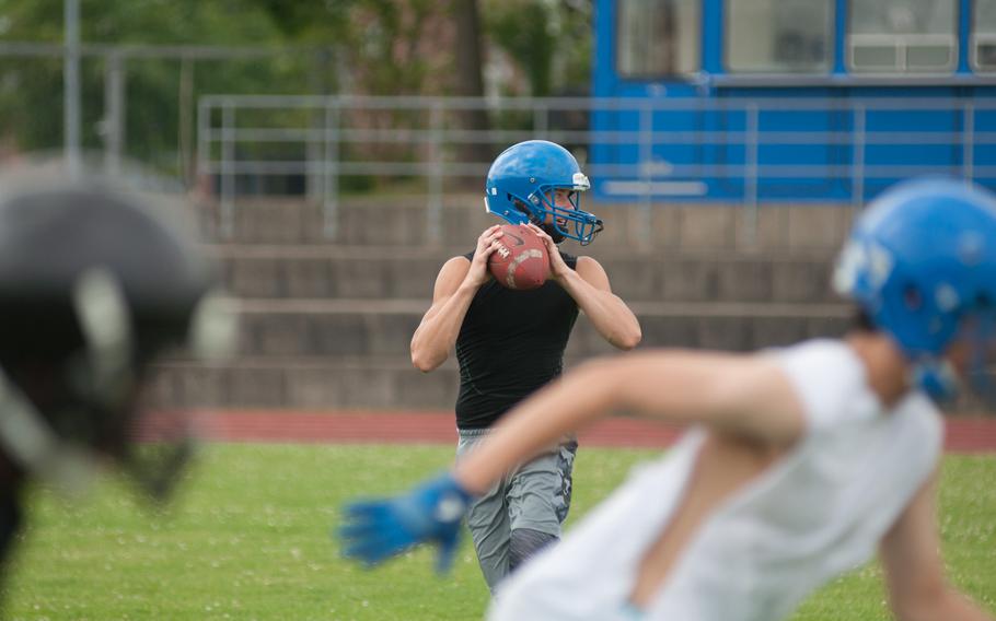 Ansbach's Bailey Ward drops back to pass during a fundamental skills football camp held on his home field, June 13, 2015. 