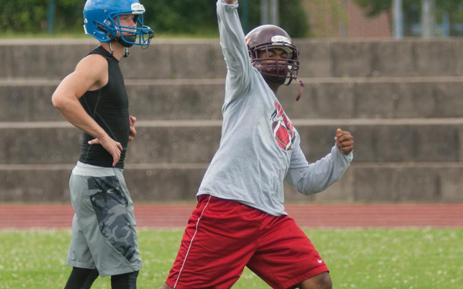 Vilseck's Drew Pinckney lets it fly, while Ansbach's Bailey Ward looks on, during a pass and catch session at a football camp held at Ansbach, June 13, 2015. 