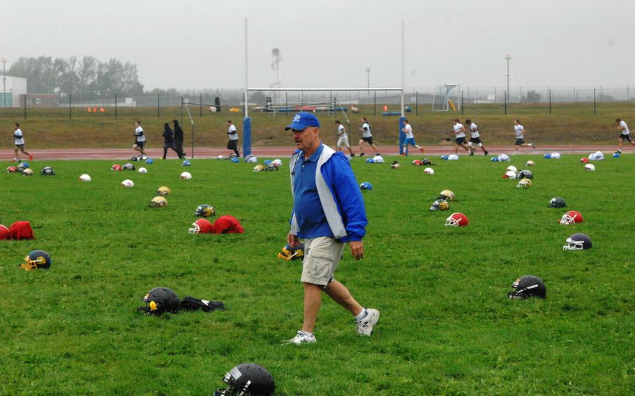 Ansbach Cougars head coach and camp organizer Marcus George strides through a sea of helmets at the European Football Camp on Monday, Aug. 17, 2015 at Ansbach High School on Katterbach Kaserne in Ansbach, Germany.
