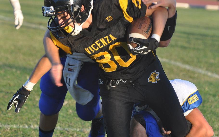 Vicenza's Kristian Rodriguez fights for more yardage after making a short catch Friday against Ansbach. The Cougars from north of the Alps defeated their feline counterparts to the south 48-16.