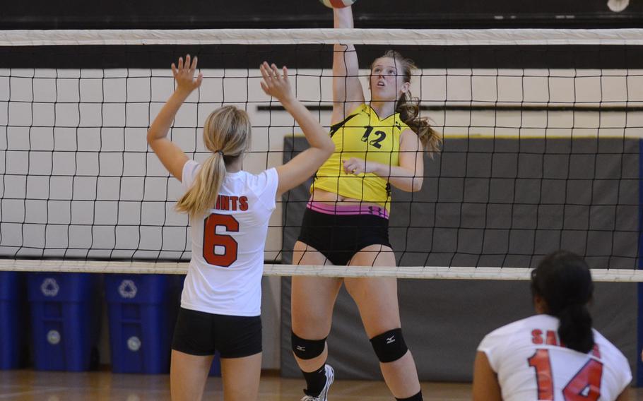 Vicenza junior Adrianna Lovelace spikes the ball past Aviano's Macie Dunn on Saturday during a match at Vicenza, Italy.