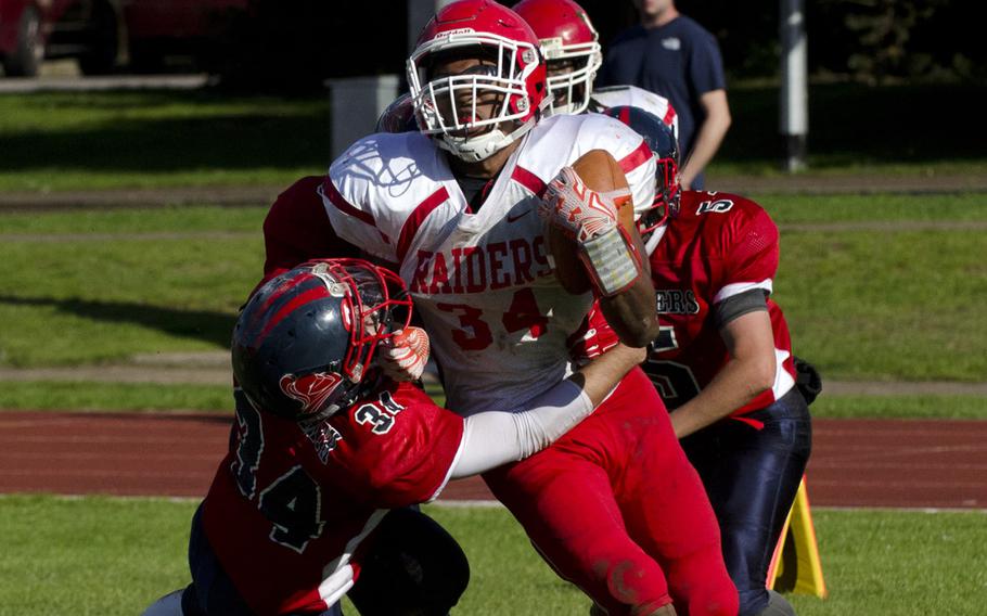 Kaiserslautern's David Zaryczny rushes while Lakenheath's Casey Stangl holds on during a football game at RAF Lakenheath, England, on Saturday, Sept. 19, 2015. Stangl had eight tackles during the game.
