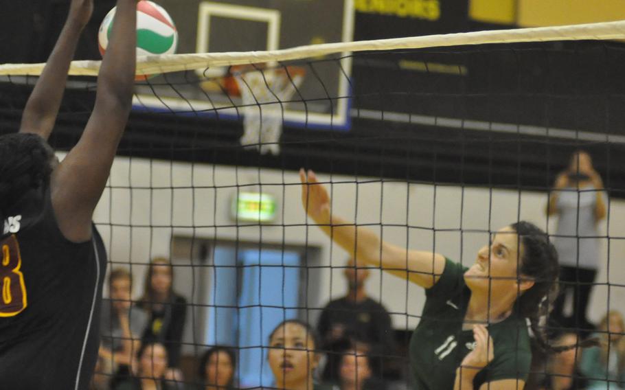 Naples' Angelica Sheils hits the ball into a block from Vilseck's Mahogany Lediju on Friday night in Vicenza, Italy. The Wildcats topped the Falcons 25-18, 25-16, 25-16.