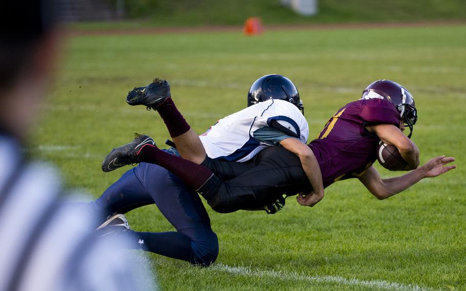 Baumholder's Solo Turgeon is brought down by Bitburg's Trevor Getty during a football game in Baumholder, Germany, Friday, Sept. 25, 2015. The visiting Bitburg Barons defeated the Baumholder Bucs 46-0.