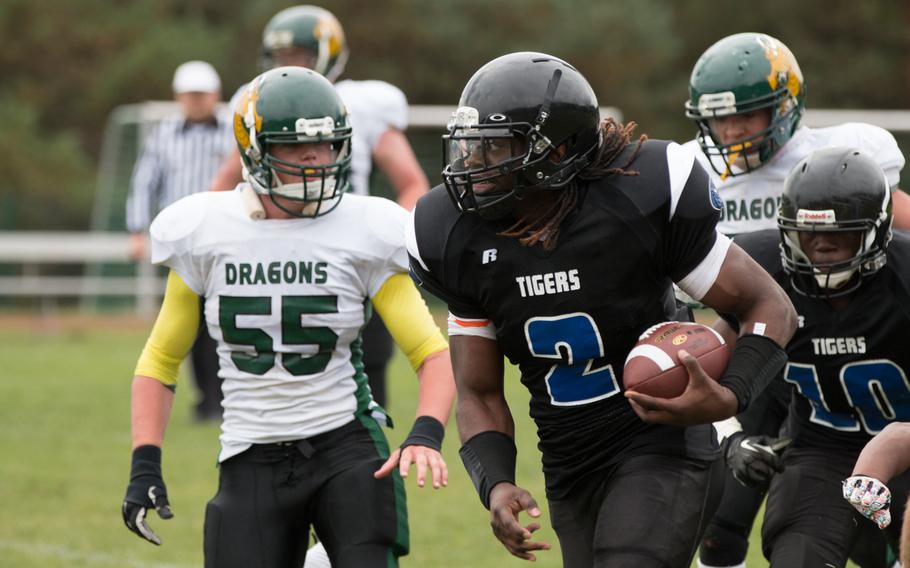 Hohenfels' Tiger Tony Saintmelus burns past an exhausted Joey Williamson during the second game of the 2015 DODDS-Europe Division II football season, Sept. 26, 2015. The Tigers shutout the Dragons, 43-0.
