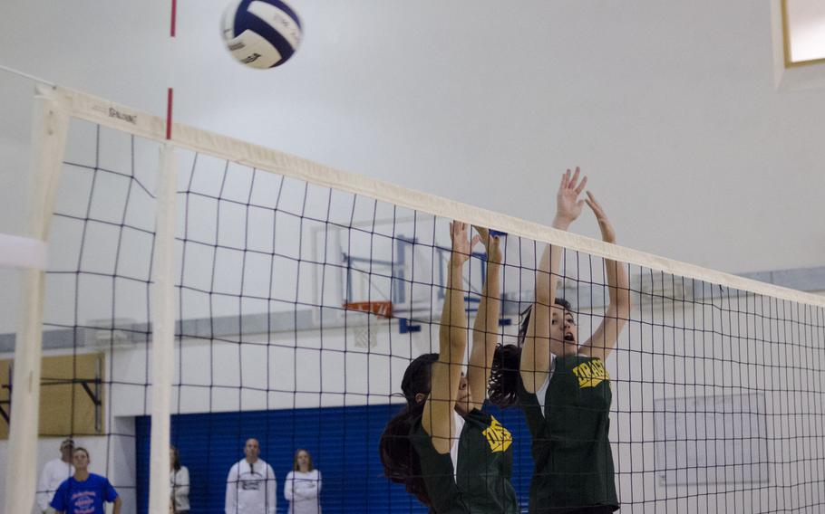 Alconbury volleyball players attempt a block during a game against Ramstein at RAF Lakenheath, England, on Saturday Oct. 3, 2015. Alconbury lost the match in three sets.