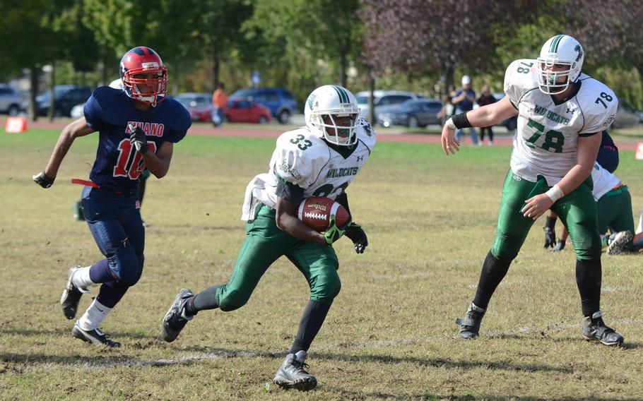 Naples running back Christopher Green finds running room in front of Aviano's Lorenzo King during Saturday's football game at Aviano Air Base, Italy. Green carried the ball 18 times for 164 yards.