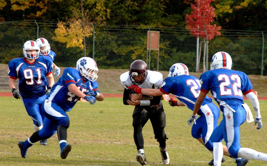 Ramstein tacklers converge on Vilseck ball carrier Austin Archangel in the Royals' 20-7 victory on Saturday, Oct. 24, 2015 at Ramstein Air Base, Germany. The Falcons were eliminated from postseason contention with the loss.