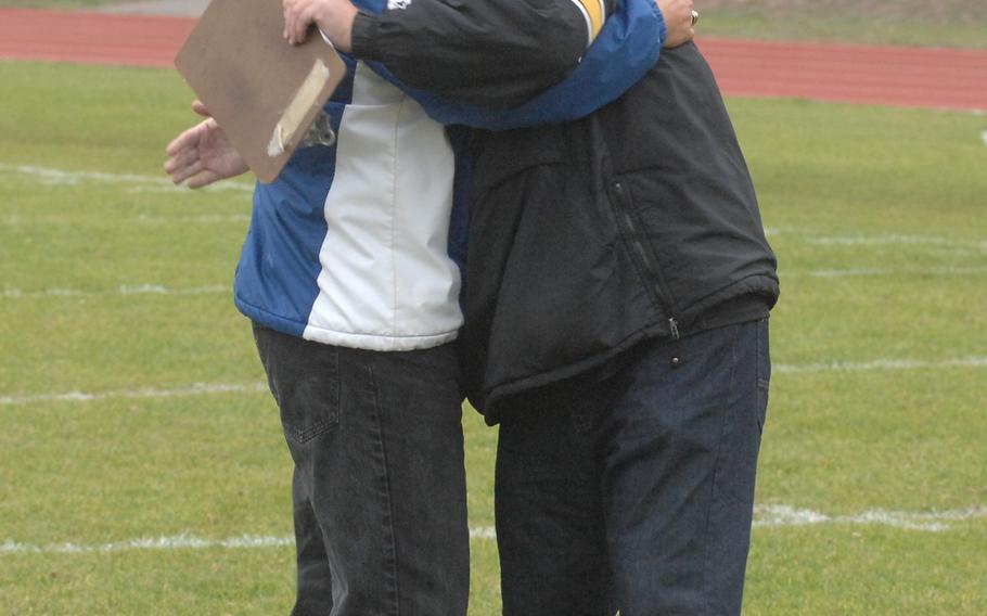 Ramstein coach Carlos Amponin and Stuttgart coach Billy Ratcliff embrace after the Stuttgart Panthers' 10-8 defeat of the Ramstein Royals on Saturday, Oct. 31, 2015. 