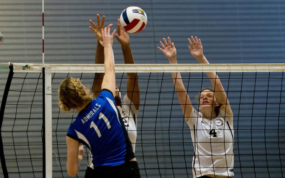 Rota Admiral Janae Curtice hits the ball past American Overseas School of Rome defenders Carolina Burgin, right, and Margo Snipe during a DoDDS-Europe championship tournament match at Ramstein Air Base, Germany, on Thursday, Nov. 5, 2015. The Admirals defeated the Falcons 26-24 and 25-15.