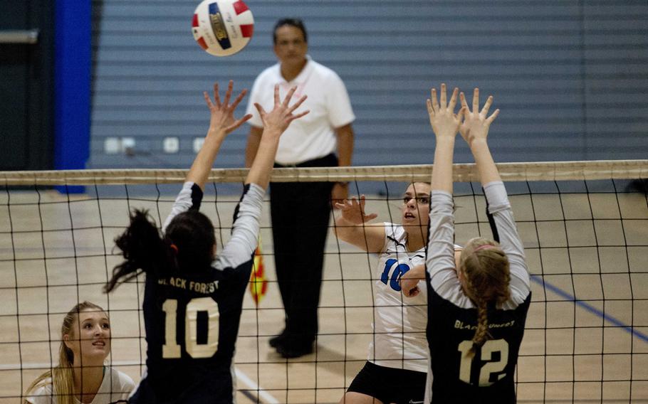 Rota Admiral Tayla Irby gets a shot past Black Forest Academy Falcon defenders during a DODDS-Europe Division II semifinal match at Ramstein Air Base, Germany, on Friday, Nov. 6, 2015. The Admirals defeated the Falcons 25-20, 25-10 and 25-11.