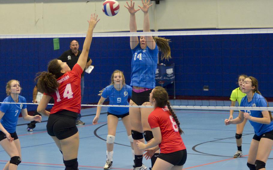 Eslise Rasmussen, a junior middle hitter from Bitburg, spikes the ball against Adrianna Lovelace of Vicenza during the inaugural DODDS-Europe volleyball all star game Saturday, Nov. 14, 2015, at Ramstein Air Base, Germany. The game was an opportunity for the best junior and senior players from across DODDS schools in Europe to play at a high level against their peers one final time.