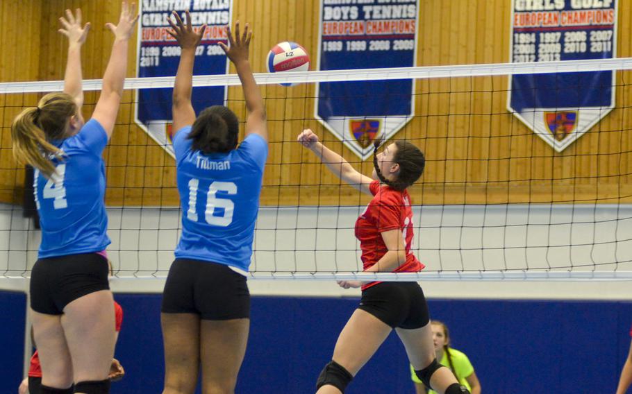 Julia Smith, right, a junior outside hitter from Stuttgart, hits the ball over the net against challenges from Adrianna Lovelace, left, of Vicenza and Eliyah Tillman of Baumholder during the inaugural DODDS-Europe volleyball all star game Saturday, Nov. 14, 2015, at Ramstein Air Base, Germany.