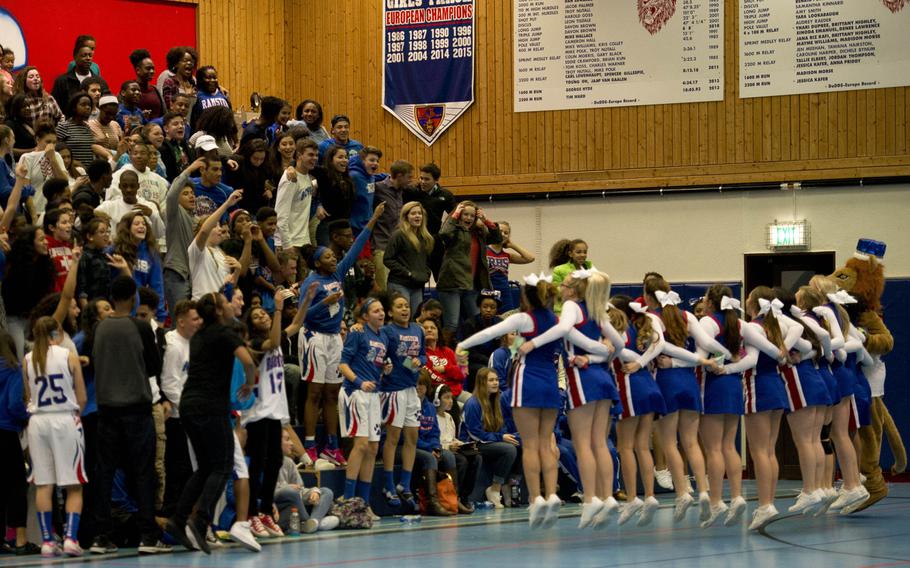 Fans cheer with the Ramstein Royals cheerleaders during a game against the Vilseck Falcons at Ramstein Air Base, Germany, on Friday, Dec. 4, 2015.