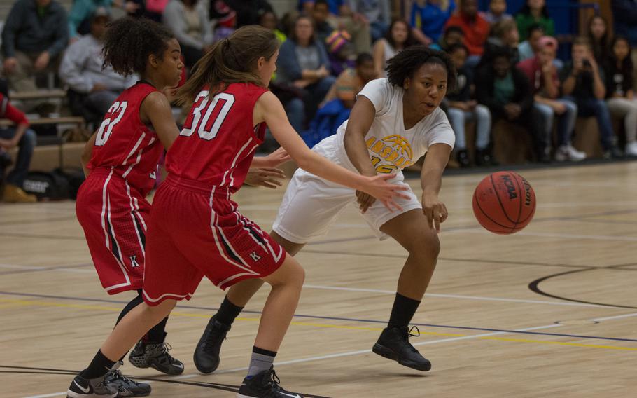 The Kaiserslautern Raiders took the DODD-Europe basketball season opener, defeating the Cougars on the road 35-12, Dec. 4, 2015. Tytianna Martinez passes past two Raider defenders during their Friday night match.