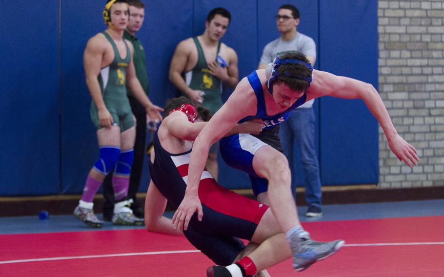 Lakenheath's Manny Cordero pulls down Brussels' Canyon LaClair during a wrestling meet at RAF Lakenheath, England, on Saturday, Dec. 12, 2015. LaClair won the bout with a pin.