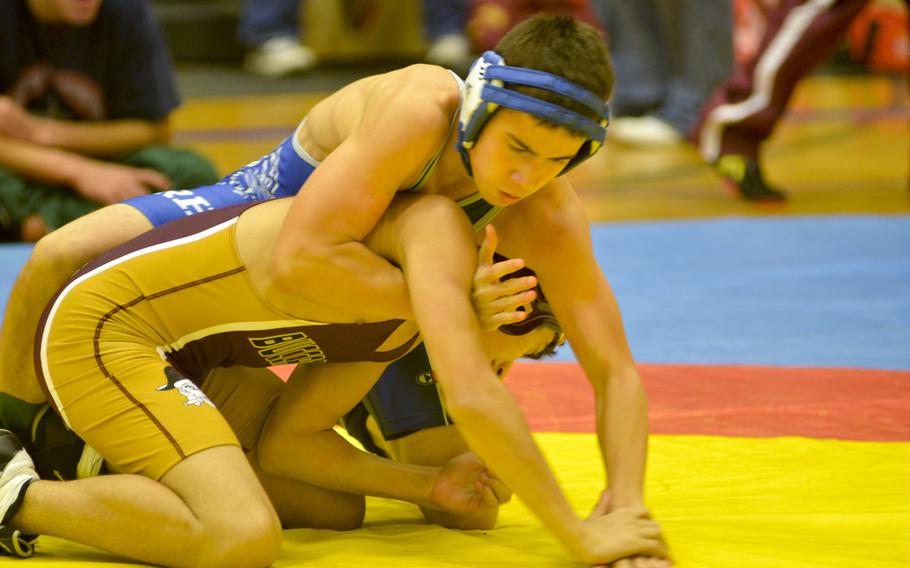 Ramstein's Nickolas Sanchez grapples with Baumholder's Aeden Ochoa in a 126-pound matchup Saturday at Wiesbaden High School. Sanchez won the match to earn third place in the division, helping Ramstein take top honors.