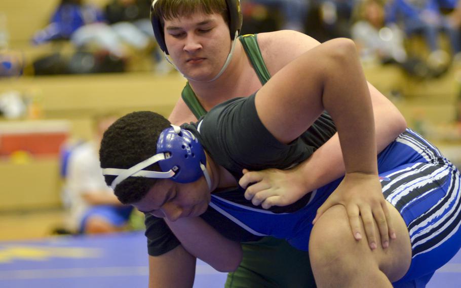 SHAPE's Chris Davidson attempts to place a hold on Ramstein's Taylor Mendenhall during a 220-pound clash in a five-team meet Saturday in Wiesbaden. Mendenhall would win the weight class, with Davidson in third.
