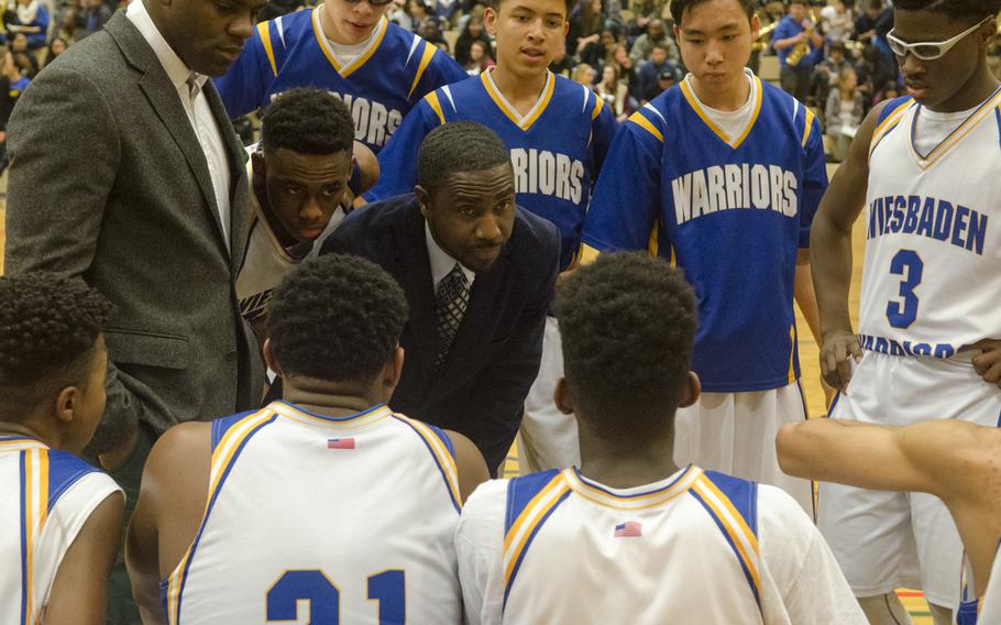 Wiesbaden head coach David Brown, center, addresses his players during a timeout in a boys basketball game Friday, Jan. 8, 2016 in Wiesbaden. The hosts defeated the visiting Cougars 76-37 on the back of a 20-3 surge to open the second half.