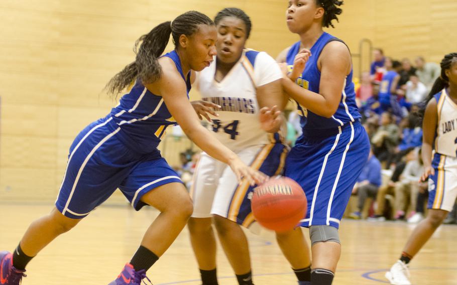 Ansbach's Tytianna Martinez, left, utilizes the pick of teammate Khiya Coats on Wiesbaden's Kiana Sterns in a girls basketball game Friday, Jan. 8, 2016 in Wiesbaden. Host Wiesbaden, two-time defending champion of Division I, defeated the Cougars of Ansbach 42-20.