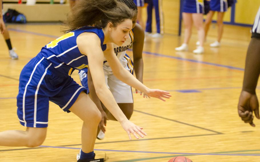 Shaneeka Boyles of Ansbach scrambles for a loose ball under pressure from Tonika Williams of Wiesbaden in a girls basketball game Friday, Jan. 8, 2016 in Wiesbaden. Host Wiesbaden, two-time defending champion of Division I, defeated the Cougars of Ansbach 42-20.