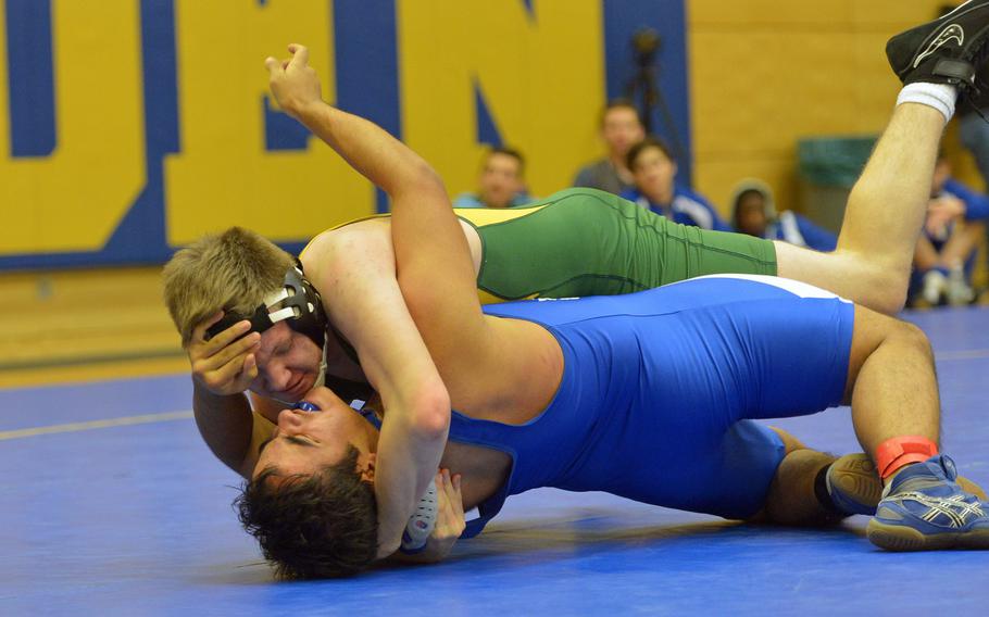 SHAPE's Logan Mans grapples with Bryant Gonzales of Brussels in a 182-pound match at Wiesbaden, Germany, Saturday, Jan. 16, 2016. Mans won the exciting match at the meet that featured host Wiesbaden, AFNORTH, Baumholder, Bitburg, Brussels, Rota and SHAPE 