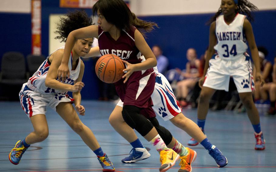 Vilseck Falcon Lahaina Bell dribbles past Ramstein defenders in a game at Ramstein, Friday, Dec. 4, 2015. Vilseck heads to Vicenza this weekend, while the Royals will host Lakenheath.