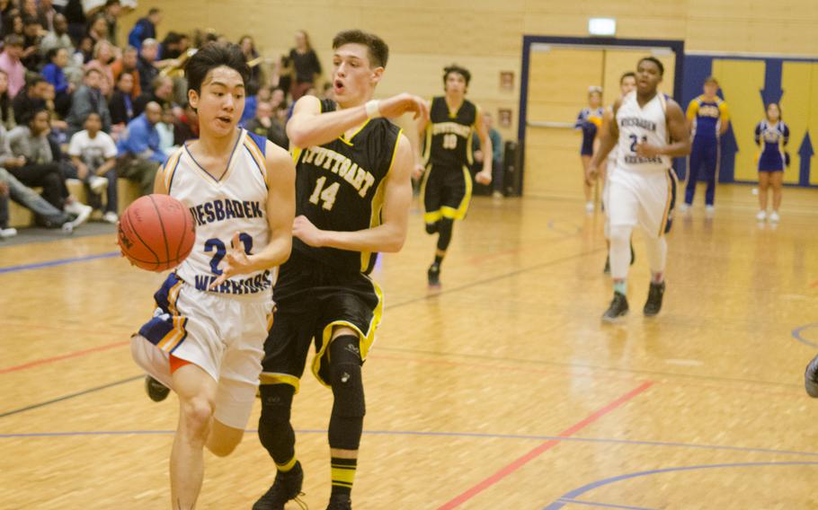 Wiesbaden's Patrick Yi dribbles beyond Tristen Phelps of Stuttgart during a boys' varsity basketball game Friday, Feb. 5, 2016 in Wiesbaden, Germany. 