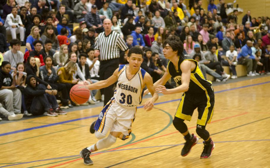 Wiesbaden's Elijah Eddings attempts to get past Stuttgart's Sam Dillon during a boys' varsity basketball game Friday, Feb. 5, 2016 in Wiesbaden, Germany. 