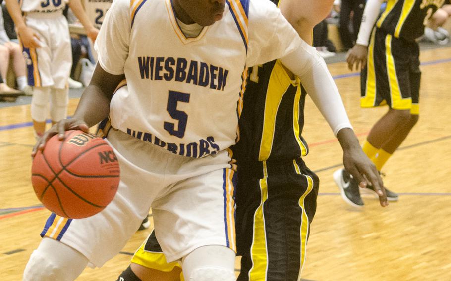 Wiesbaden's Jalan Glover dribbles along the baseline during a boys' varsity basketball game against Stuttgart Friday, Feb. 5, 2016 in Wiesbaden, Germany. 