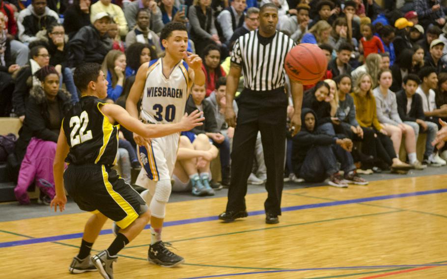 Wiesbaden's Elijah Eddings makes a pass beyond Stuttgart's Ben Nix during a boys' varsity basketball game Friday, Feb. 5, 2016 in Wiesbaden, Germany. 