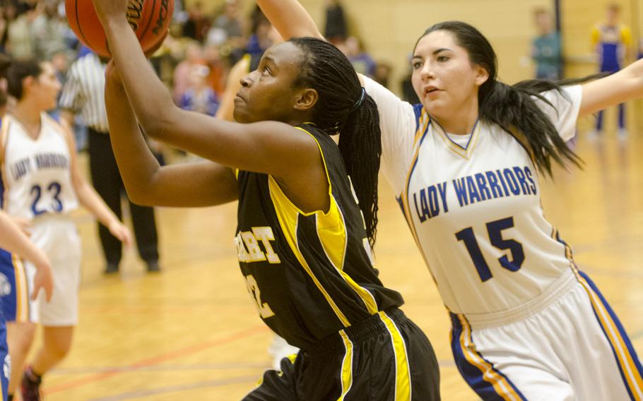 Garcelle Sampson of Stuttgart takes a shot as Wiesbaden's Shelaylah Steele defends during a girls' varsity basketball game Friday, Feb. 5, 2016 in Wiesbaden, Germany. Stuttgart triumphed 45-10 off of a strong defensive effort.