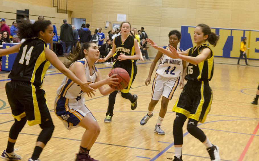 Wiesbaden's Elizabeth Hall fights through Stuttgart defenders during a girls' varsity basketball game Friday, Feb. 5, 2016 in Wiesbaden, Germany. Stuttgart triumphed 45-10 off of a strong defensive effort.
