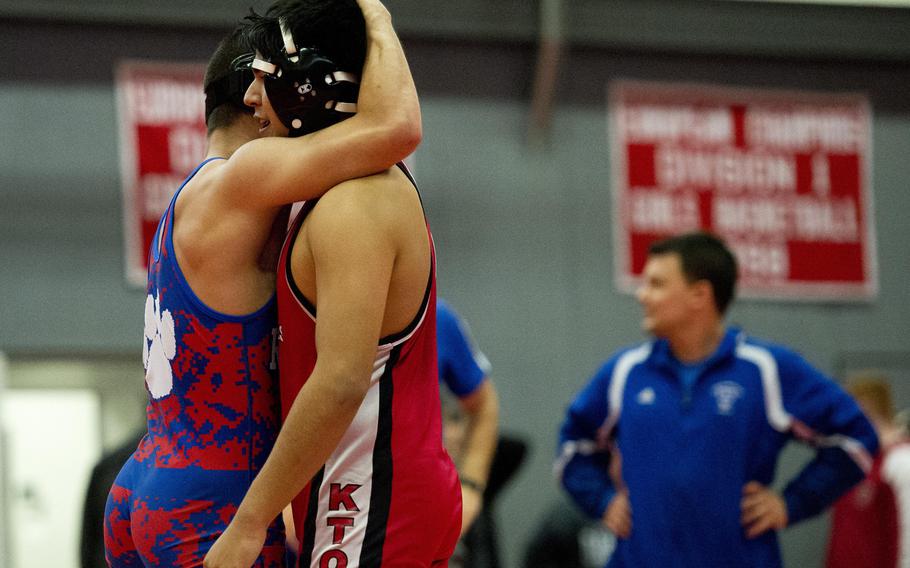 Ramstein's Chad Chason embraces Kaiserslautern's Dante Rincon during the DODDS-Europe Central Sectionals meet at Vogelweh, Germany, Saturday, Feb. 13, 2016. Chason defeated Rincon during the match.
