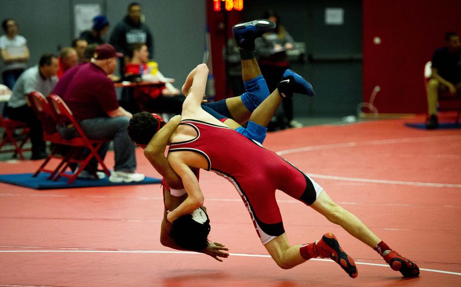 Kaiserslautern's Paul Linehan takes down Bitburg's Kurt Nacionales during the DODDS-Europe Central Sectionals meet at Vogelweh, Germany, Saturday, Feb. 13, 2016. Nacionales eventually defeated Linehan.
