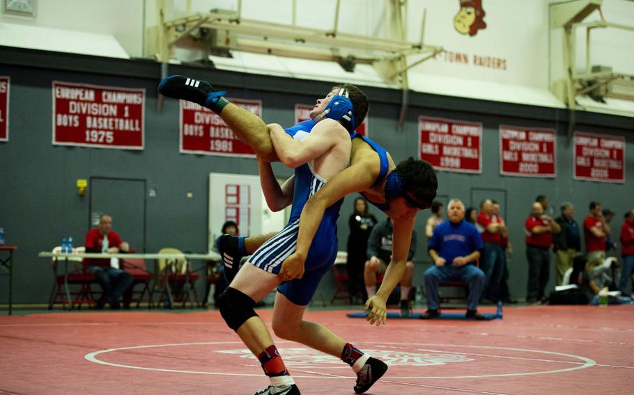 Ramstein's Brandon Voros flips Hohenfels' Jacob Benavides during the DODDS Central Sectionals meet at Vogelweh, Germany, Saturday, Feb. 13, 2016. 
