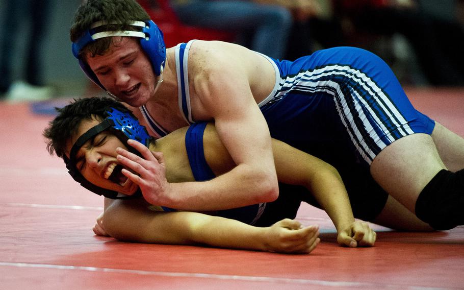 Ramstein's Brandon Voros tries to subdue Hohenfels' Jacob Benavides during the DODDS-Europe Central Sectionals meet at Vogelweh, Germany, Saturday, Feb. 13, 2016. The top three wrestlers in each weight class will go on to the DODDS European championship in Wiesbaden next weekend.