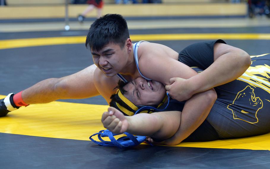 Ramstein's Clesson Allman tries to finish off Stuttgart's Jacob Puentes  in a 285-pound match in opening-day action at the DODDS-Europe wrestling championships in Wiesbaden, Germany, Friday, Feb. 19, 2016. Puentes got out of the jam but lost in an 18-12 decision to Allman in an exciting first-round match.