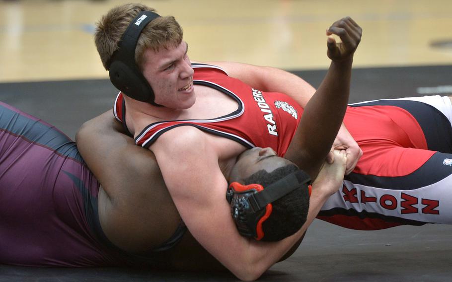 Royce Staley has a lock on Vilseck's Darnel Pitts in a 220-pound match in opening-day action at the DODDS-Europe wrestling championships in Wiesbaden, Germany, Friday, Feb. 19, 2016. Staley won.