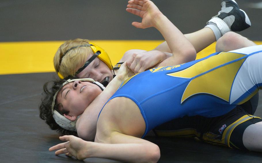 Stuttgart's Benjamin Fielding, rear, has Wiesbaden's Joey Krapf in his grip on his way to winning the first-round 120-pound match at the DODDS-Europe wrestling championships in Wiesbaden, Germany, Friday, Feb. 19, 2016.