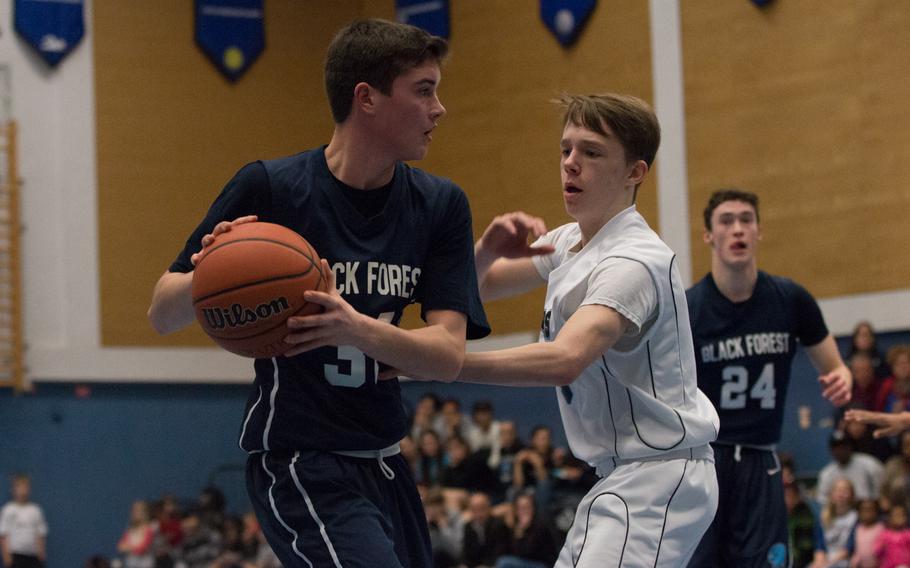 Black Forest Academy's Jason Kragt looks to pass during the Falcons' 51-12 win over the Hohenfels Tigers during an end-of-the-season meeting between the two teams at Hohenfels, Friday, Feb. 19, 2016. 
